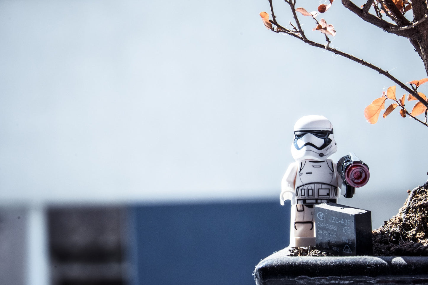 Lego storm trooper and a discarded battery in nature