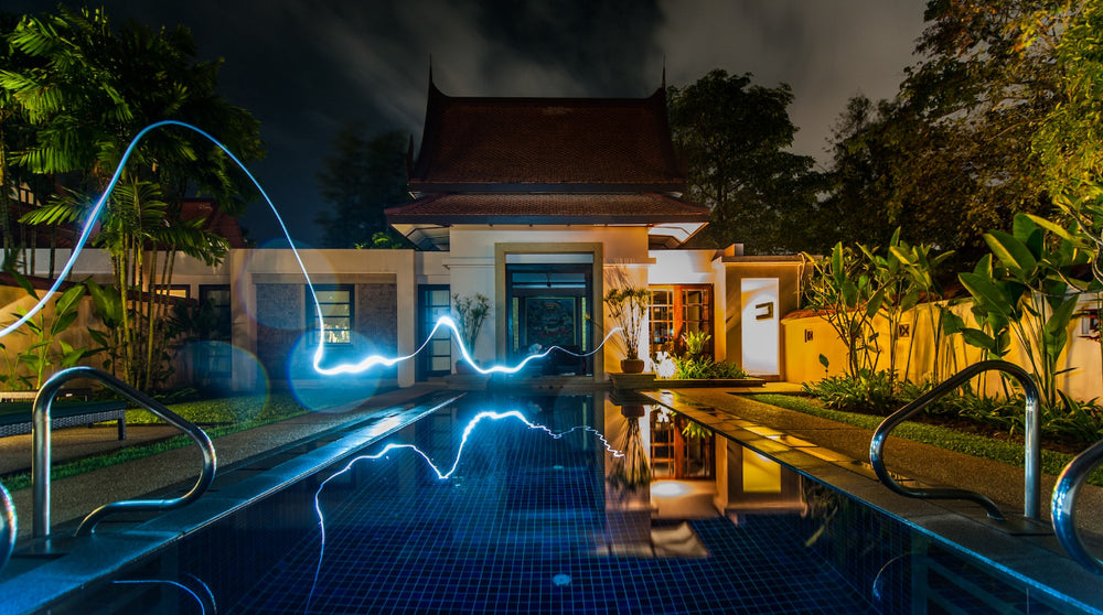 Home with pool and blue stream of light moving towards it