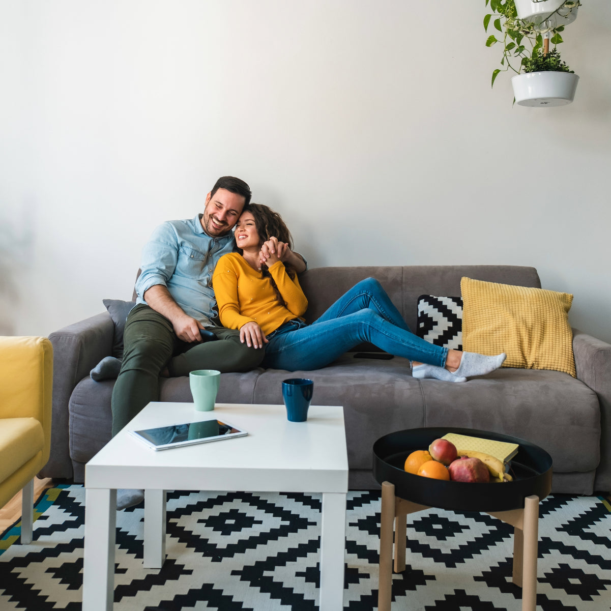 Couple smiling and relaxing in living room