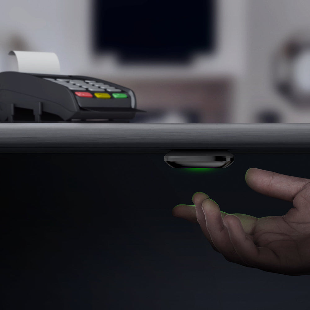 
                  
                    a hand is pressing an AJAX Smart Button installed under a cash point
                  
                