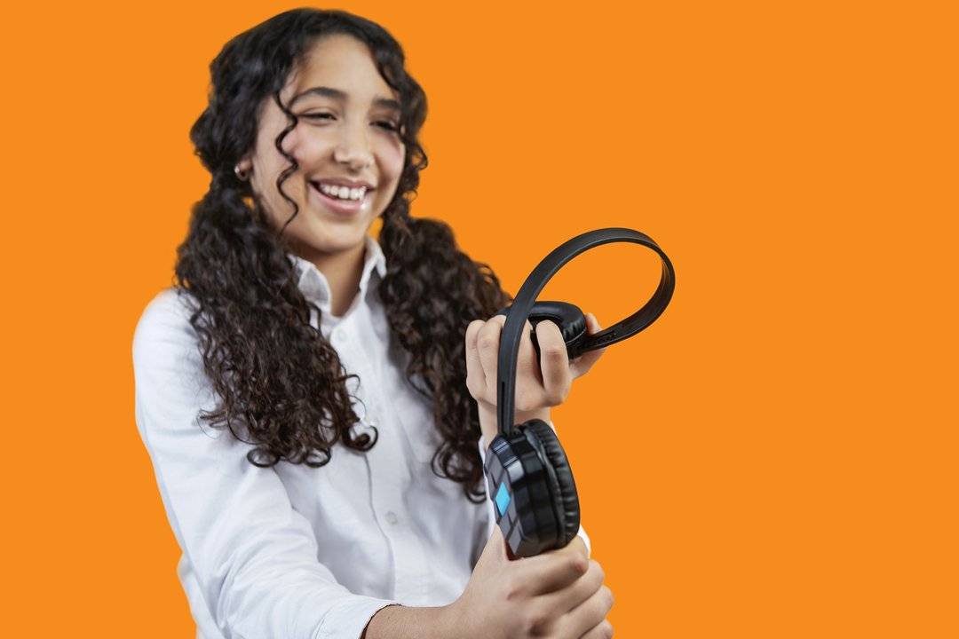 
                  
                    Girl holding DropTech Headset
                  
                